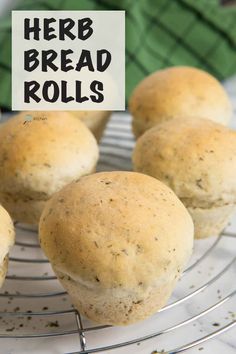 there are some muffins on a wire rack with a sign that says herb bread rolls