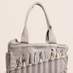 a tool bag with seven tools in it and the handles are lined up to hold them