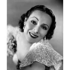 a black and white photo of a woman with an angel wings on her shoulder, smiling