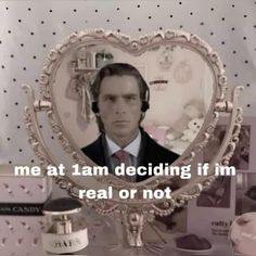 a man with headphones in front of a heart shaped mirror that says, me at i am deciding if i'm real or not