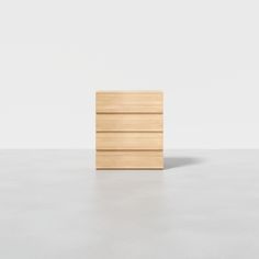 a wooden drawer sitting on top of a white floor