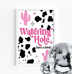 a disco ball next to a poster with the words, watering hole have a drink