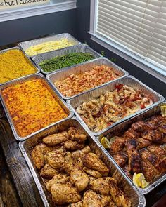 several trays of food sitting on top of a table