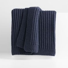 two dark blue knitted towels folded on top of each other