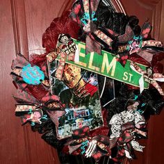 a close up of a wreath on a door with some pictures and ribbons around it