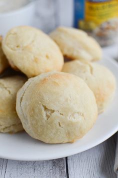 some biscuits on a white plate next to a bottle of milk