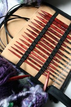 several knitting needles in a case on a table