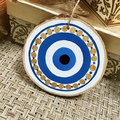 a blue and white plate hanging from a rope on a wooden box next to other items