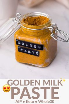 a jar filled with golden milk paste sitting on top of a counter