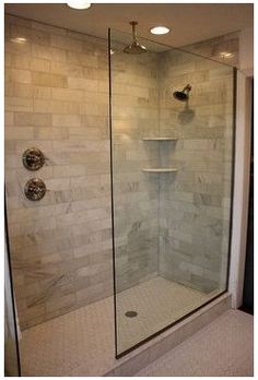 a walk in shower sitting inside of a bathroom