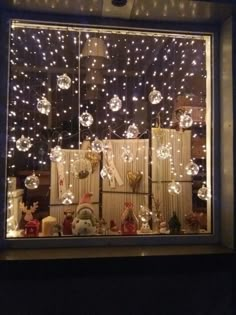 a window with christmas decorations and lights in it