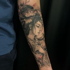 a woman with a geisha tattoo on her arm