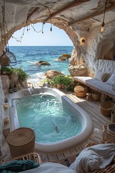 an outdoor jacuzzi tub in the middle of a room with water and rocks