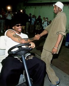 two men shaking hands while sitting in an airport