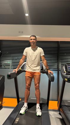 a man standing on a treadmill in the gym