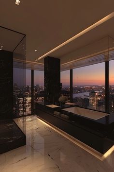 a bathroom with a large bathtub and floor to ceiling windows overlooking the city at night