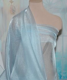 Width: 45" wide Length per listing: 1 yardPrice per yard is $4.50Type: Pageant Sparkle OrganzaColor: Light Blue Weight:5 oz'sContent:  100% NylonCare: machine washable Elegant Blue Tulle Fabric For Party, Blue Organza Tulle Fabric For Wedding, Elegant Blue Tulle Fabric For Evening, Blue Sheer Tulle Fabric For Party, Light Blue Wedding Dress, Blue Sparkly Dress, Dress Skirts, Wedding Home Decor, Light Blue Wedding