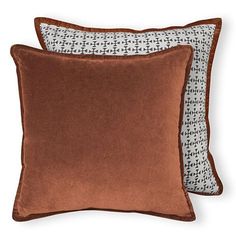 two brown and white pillows sitting next to each other