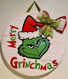 a merry grinmas sign hanging on the wall