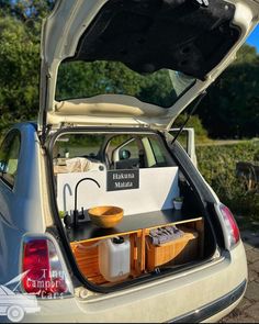 an open hatchback car trunk with items in it