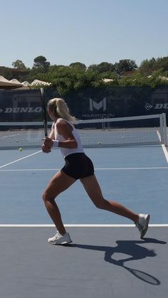 a female tennis player in action on the court