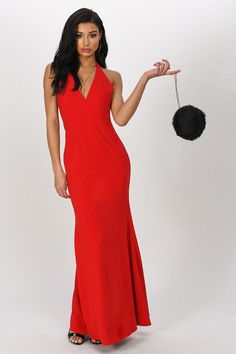 a woman in a red dress holding a pom - pom