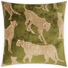 a green pillow with leopards and cheetah silhouettes on the front in gold foil