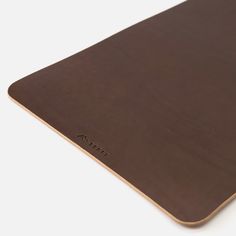 a brown mouse pad sitting on top of a white table