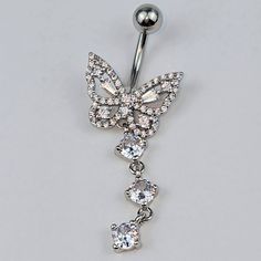 a butterfly belly ring with crystal stones hanging from it's side