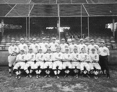 the baseball team is posing for a photo in front of an empty bleachers