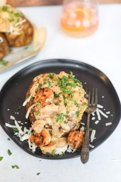 a black plate topped with food next to a fork