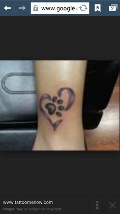 a dog paw print tattoo on the wrist and foot, with an image of a heart shaped