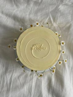 a birthday cake sitting on top of a white sheet