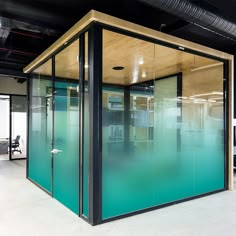 an office cubicle with glass walls and doors