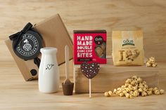 an assortment of snacks including popcorn, marshmallows, and coffee on a wooden table