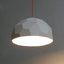 a white light hanging from a ceiling in a room with grey walls and flooring