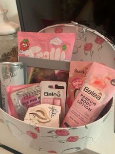 a basket filled with lots of different types of cosmetics and personal care products on top of a counter