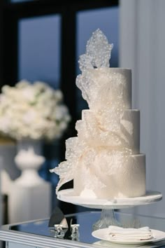 a white wedding cake sitting on top of a table