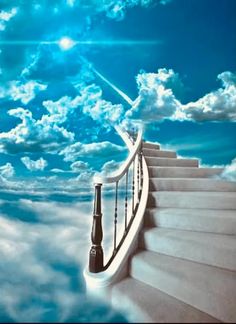 a stairway leading up into the sky with clouds