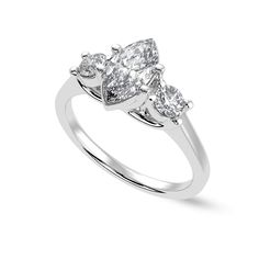 three stone diamond ring in white gold with diamonds on the shoulders and sides, set against a plain background