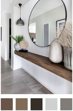 there is a mirror and vases on the shelf in this room with tile flooring