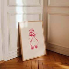 a drawing of a teddy bear is on the floor next to a framed print that says, i love you