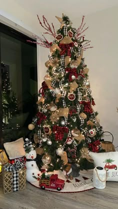 a christmas tree decorated with red, black and gold ornaments