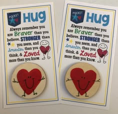 two magnets that say hug and have hearts on them