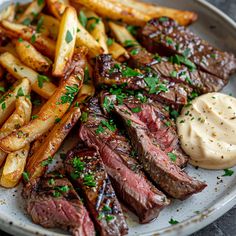 steak, fries and sauce on a plate