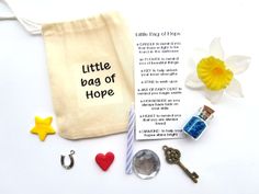 a little bag of hope is on the table next to some keys and other items