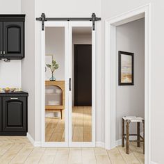 an empty kitchen with black cabinets and white walls