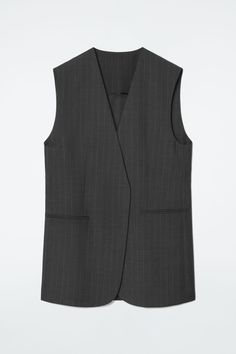 Classic tailoring meets modern design codes in this charcoal vest. Made from RWS wool, it's woven with subtle pinstripes and cut in an elongated, wrap-front shape. Style it as a suit with the matching pants. Regular fitFront welt pocketsThis product contains Responsible Wool Standard TE-00047206 (RWS) wool fiber from farms certified to animal welfare and land-management requirements  Shell: 100% RWS Wool. Lining: 100% Viscose. Excluding trims / Dry clean Back length of size 6 is 30.43" / Model wears a size 6 Tailored Wool Vest, Tailored Pinstripe Sleeveless Vest, Tailored Sleeveless Pinstripe Vest, Tailored Wool Single-breasted Vest, Pinstripe Waistcoat, Tailored Waistcoat, Timeless Knitwear, Striped Knitted Sweater, Wool Waistcoat