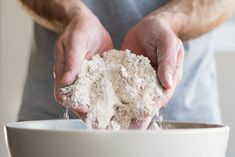 a man is mixing flour into a bowl