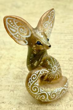 a glass figurine with an intricate design on it's head and tail